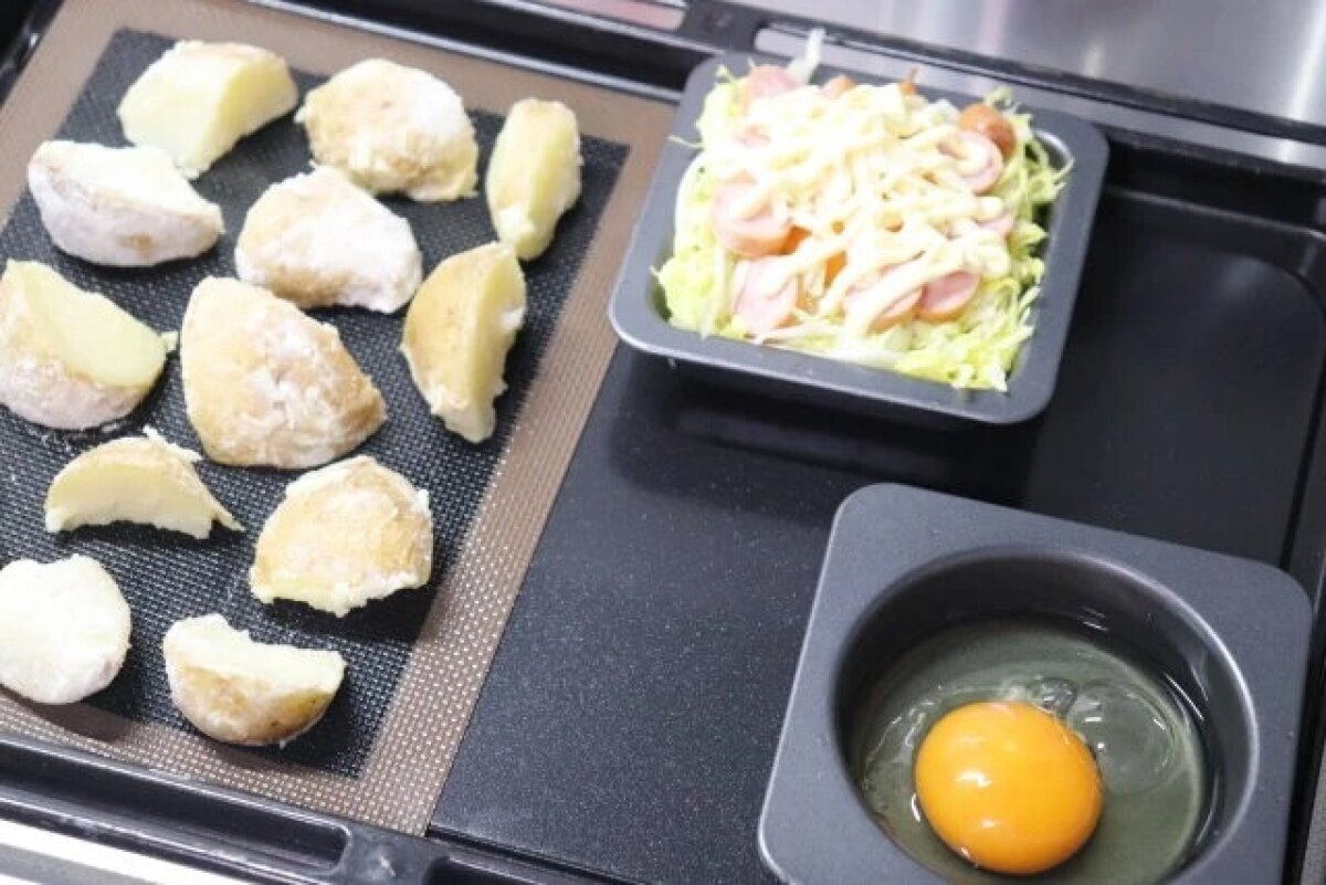 圖片顯示,圓形托盤和裝滿各種食材的托盤整齊地排列在烤盤上。 オーブンの天板に丸型トレーや具だくさんのトレーが並べて置かれている様子