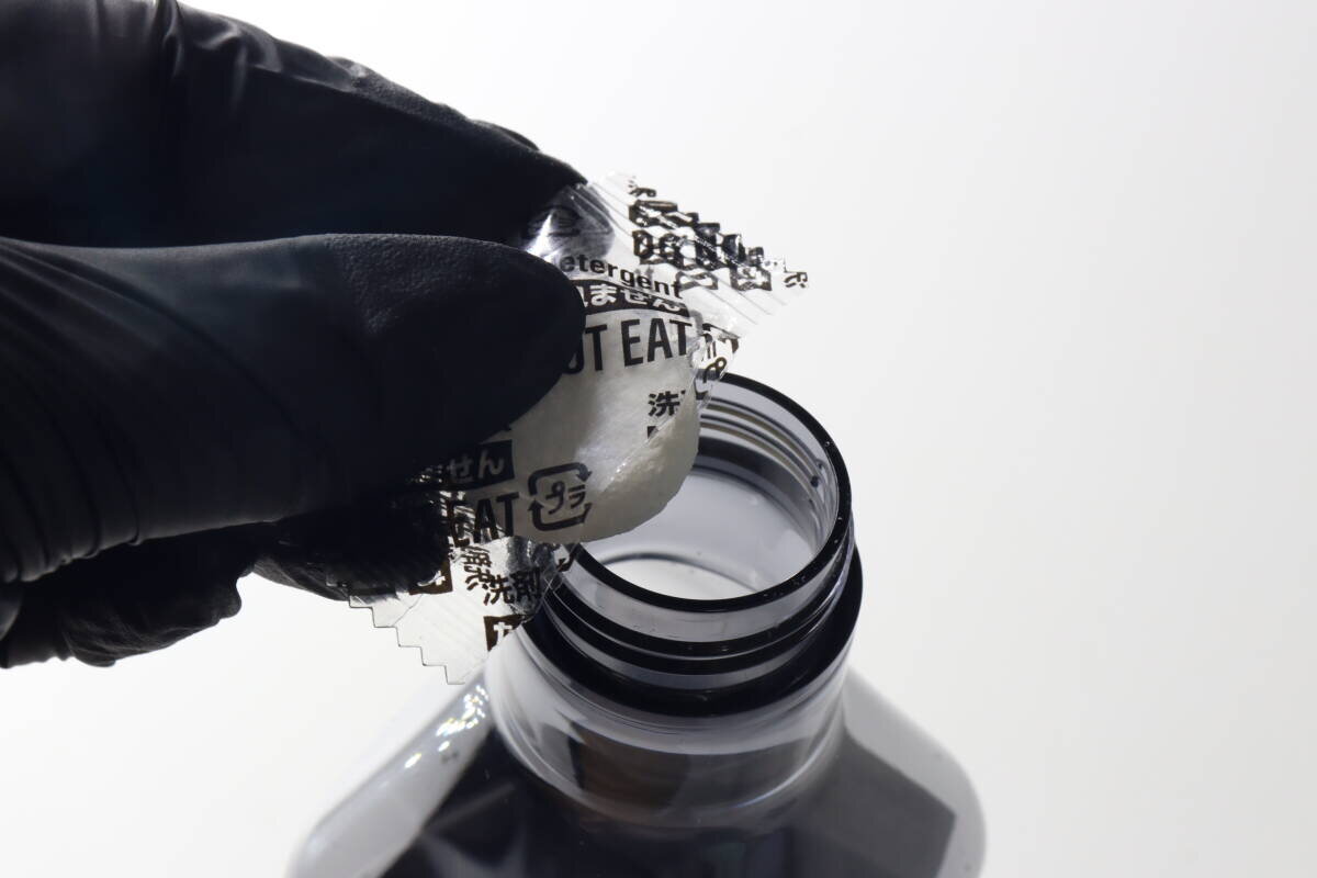 一隻戴著黑色手套的手將藥片放入噴霧瓶中的那一刻。 黒い手袋をした手で錠剤をスプレーボトルに入れている瞬間