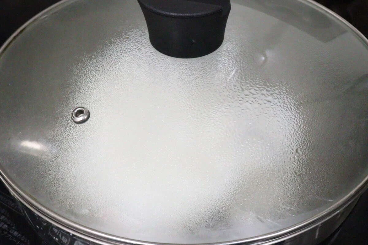 フタをした鍋の中でご飯を蒸らしている調理中の様子 フタをした鍋の中でご飯を蒸らしている調理中の様子