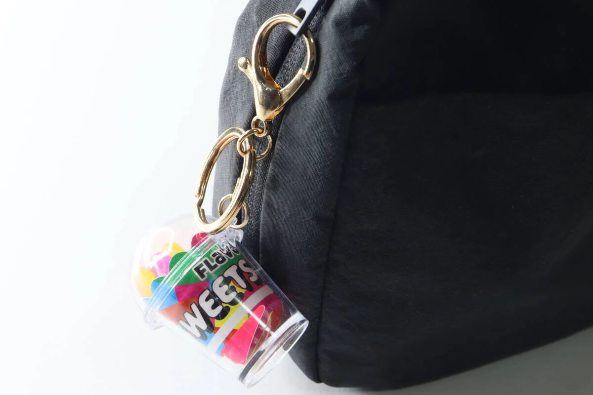 黒いリュックのファスナーにカニカンで取り付けられたキーホルダー
