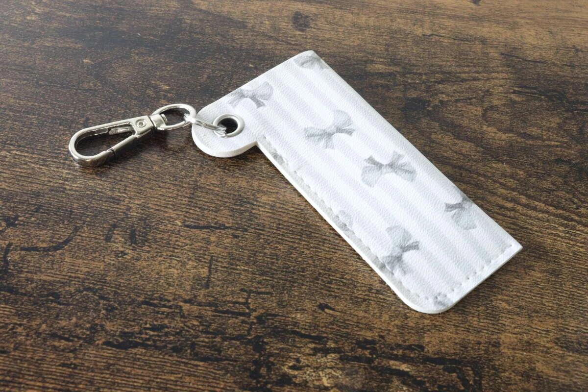 木製テーブルの上に置かれたリボン柄のリップホルダー単体 木製テーブルの上に置かれたリボン柄のリップホルダー単体