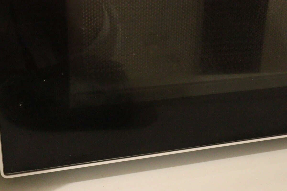 少し汚れや指紋がついている電子レンジの黒いガラス扉の様子